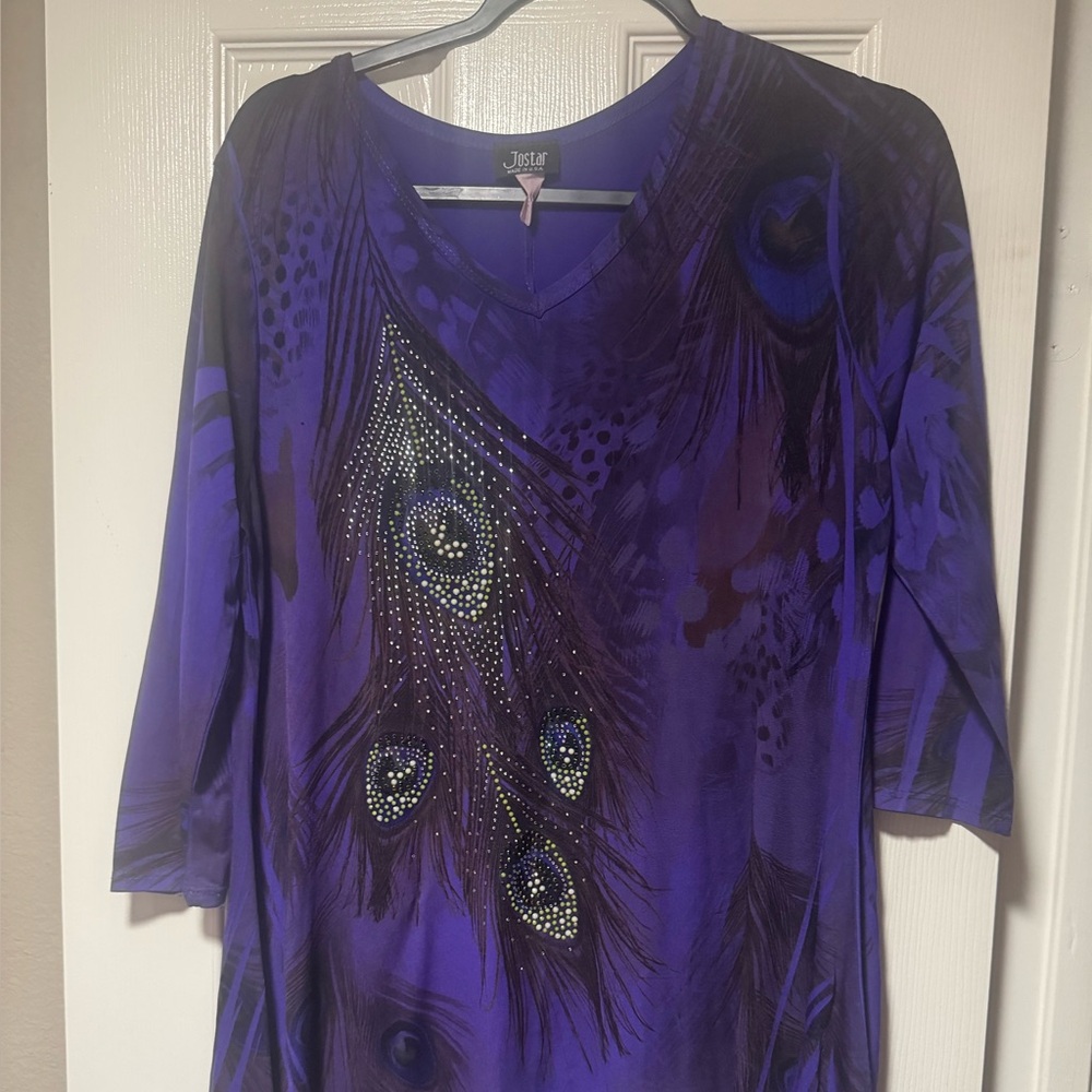 Jostar purple blouse. Embellished peacock feathers. Shark bite hem.